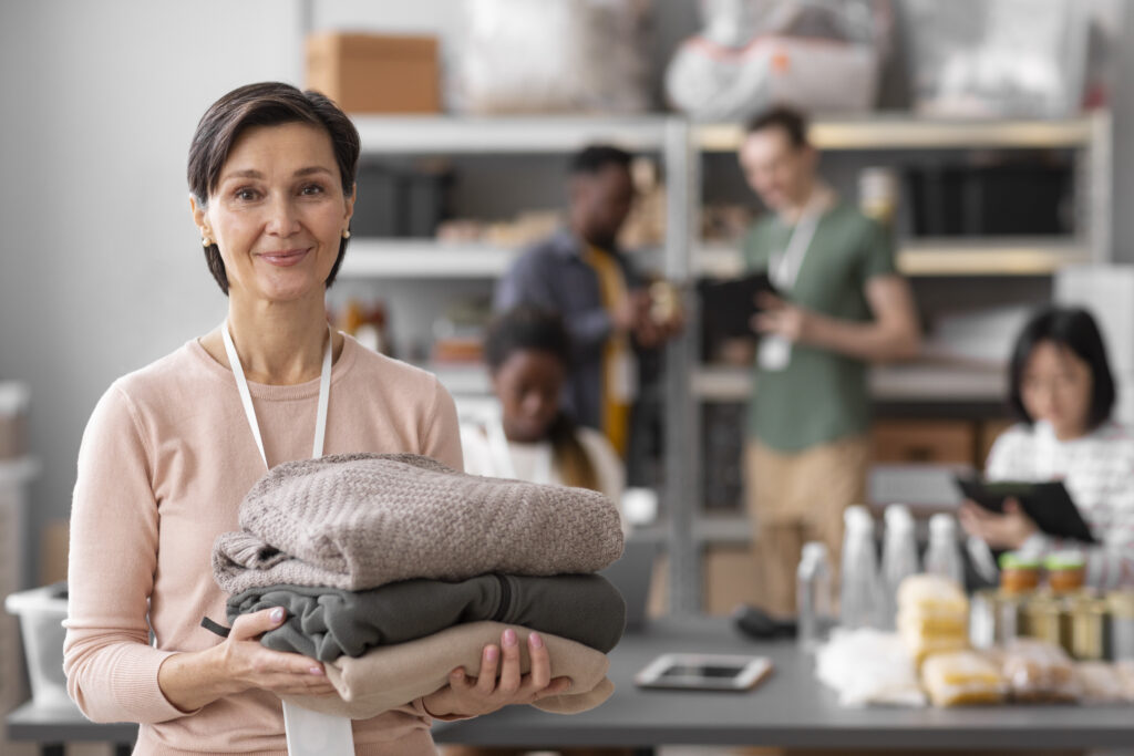 volunteer-selecting-and-organizing-clothes-donations-for-charity